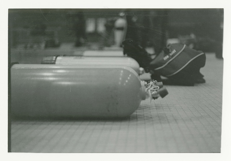 Photo of air cylindars laying on the ground in a row. Photo by Kirsten DeZeeuw