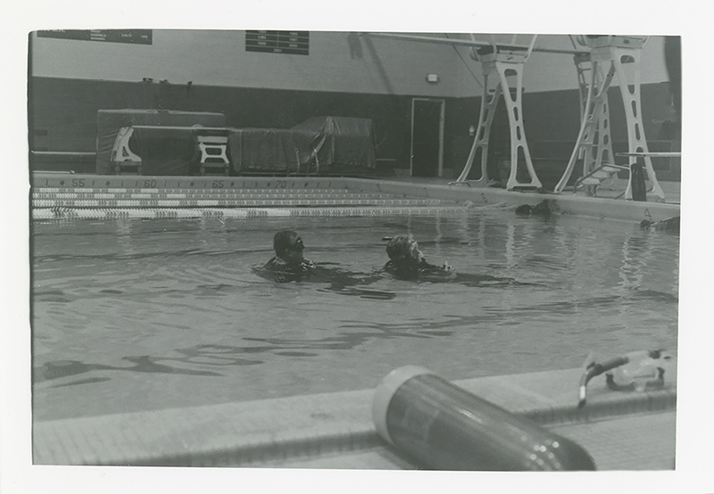 Image of two divers demonstrating a skill in the water. Photo by Kirsten DeZeeuw